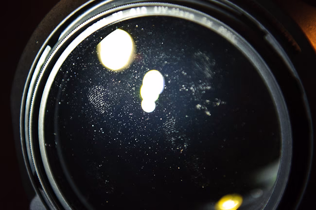 How do you get dust out of the inside of a camera lens?